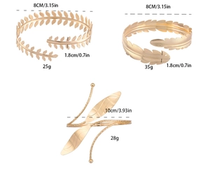 Detailed view of baroque gold arm cuffs featuring leaf patterns and feather textures