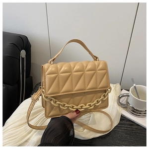 Detail showing beige triangle quilted faux leather texture with acrylic chain decoration