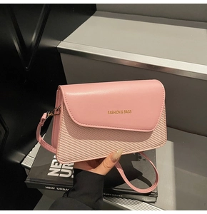 Close-up of pink leather patchwork handbag with Fashion & Bags lettering detail