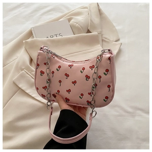 Close-up of pink cherry print shoulder bag with silver chain strap and metal zipper