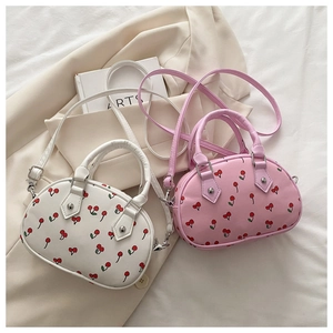 Detailansicht der rosa-weißen halbrunden Kirsch-Handtaschen mit silbernen Beschlägen