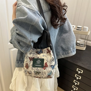 Canvas floral tote bag with butterfly print and crossbody strap for stylish women
