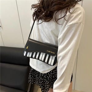 Fashionable piano keyboard shoulder bag in black and white with G-clef print for women