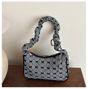 Detail of checkered shoulder bag with bow print and unique ruched cloud handle
