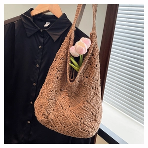 Close-up of brown crochet tote bag with rhombus knit pattern and pink tulips detail