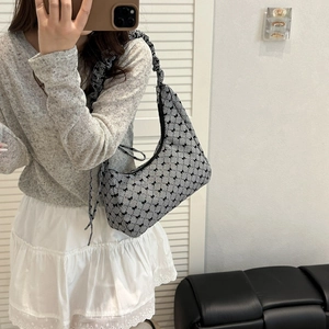 Sweet plaid hobo bag with bow detail and ruched shoulder strap shown on model