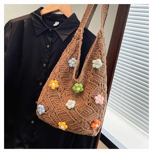 Detailed view of colorful 3D crochet flowers on a brown hollow-out knit shoulder bag