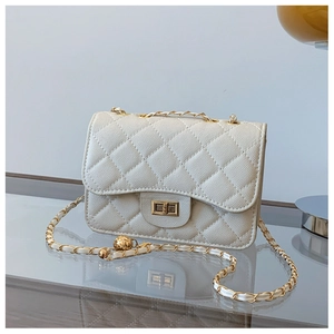 Close-up of white quilted crossbody bag featuring golden turn-lock and chain strap
