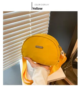 Close-up of yellow nylon crossbody bag with adjustable strap and metal JINGPIN logo