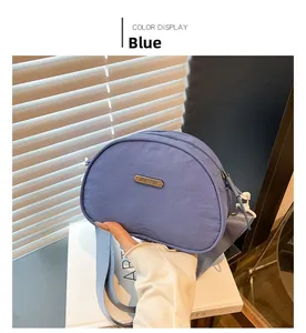 Blue nylon shell-shaped crossbody bag with JING PIN label and adjustable strap