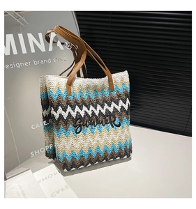 Detail einer Boho-Strohtasche mit bunten Wellenmustern und Summer-Bestickung