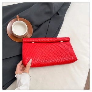 Close-up of red woven leather envelope clutch featuring a tight textured pattern and snap button