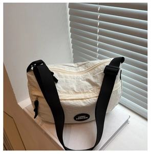 Detail of off-white tote bag with LUCKY FASHION logo and adjustable black strap