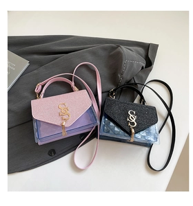 Detail of mini crossbody bags featuring glitter lid, gold SS logo and metal tassels