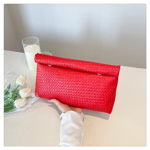 Detailed view of a red woven texture envelope clutch with a fold-over flap design