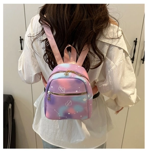 Detail of colorful galaxy mini backpack showing floral gold zippers and star patterns