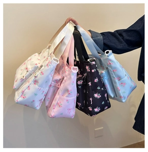 Group view of floral tote bags with pink rose prints and side zipper pockets