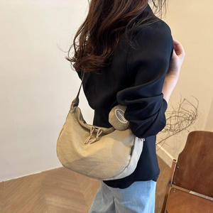 Minimalist khaki nylon crescent crossbody bag with round coin purse and drawstring detail