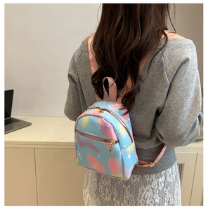 Detail of pastel mini backpack with star patterns and golden floral zippers