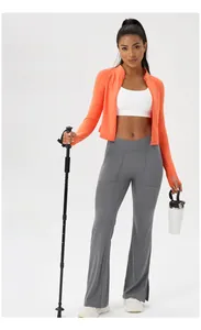 Detail of slim-fit zipper yoga jacket and V-waist yoga pants in orange and grey