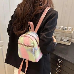 Gradient nylon backpack with candy colors and floral zipper on a model in black blazer