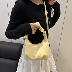 Fashionable light yellow pleated handbag with chain strap and shiny synthetic leather