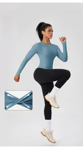 Dynamic view of high-stretch blue yoga top and detail of flexible athletic fabric