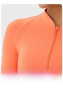 Detailed close-up of raglan sleeves and smooth zipper on coral yoga fitness jacket