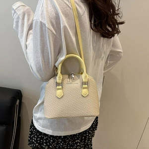 Chic beige crocodile pattern shell handbag with top handles and cross-body strap