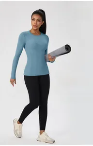 Close-up of light blue long-sleeved slim-fit yoga top with seamless fabric texture
