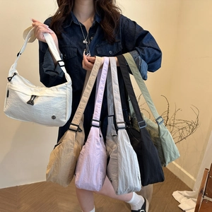 Minimalist nylon crescent crossbody bag in assorted colors with adjustable strap