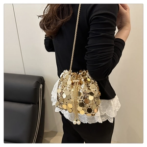Close-up of golden sequins bucket bag featuring chain strap and elegant pearl drawstring