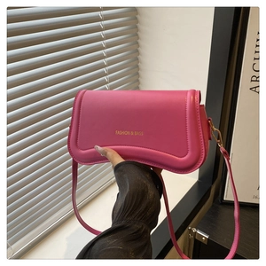 Detailed view of pink PU leather crossbody bag with FASHION & BAGS gold lettering