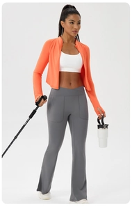 Detail of high-waist flared yoga pants with V-shaped waistband and side pockets