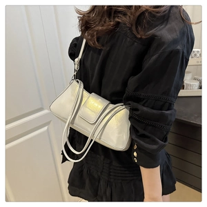 Silver baguette shoulder bag in glossy patent leather with sleek flap closure detail