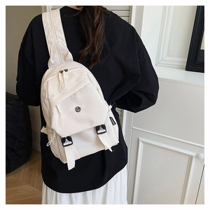 Detail showing high-capacity minimalist beige nylon backpack with functional side buckles