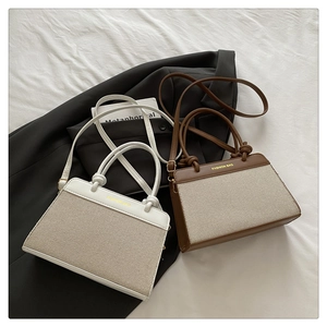 Detail of color-block tote bags in canvas and faux leather with adjustable shoulder straps