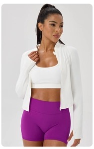 Detail of white slim-fit stand collar zip-up sports jacket with purple yoga shorts