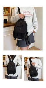 Détail du mini sac à dos en nylon noir avec poches multiples et fermetures éclair argentées