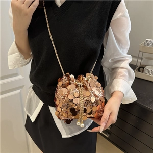 Sparkly champagne gold sequin drawstring bucket bag with chain strap and pearl accents