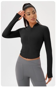 Detail of black slim-fit workout jacket showing stand collar and functional thumb holes