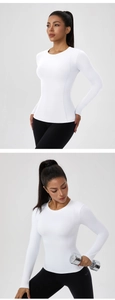 Close-up of white slim-fit long sleeve sports top and high-waist black leggings