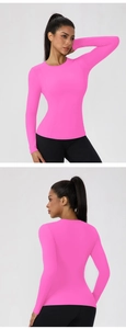 Detail view of pink slim fit yoga top showing ergonomic stitching and quick-dry fabric