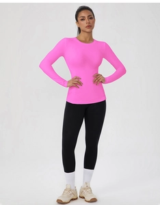 Close-up of bright pink slim fit long sleeve yoga top with high elasticity fabric