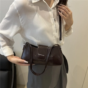 Minimalist glossy dark brown leather underarm bag with double straps in baguette style