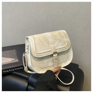 Detail of minimalist saddle bag with vintage buckle and adjustable shoulder strap