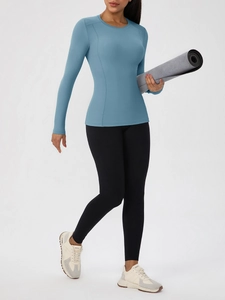 Women's blue long sleeve yoga top and black leggings set with high stretch dry fit fabric