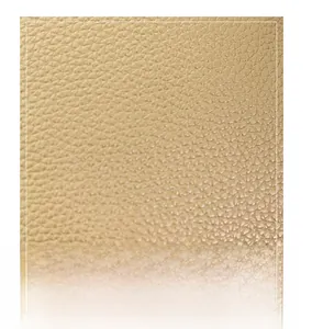 Close-up of beige lychee-patterned synthetic leather material with fine texture