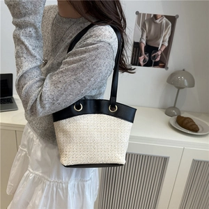 Large capacity woven straw shoulder bag with black leather trim for beach and daily commute