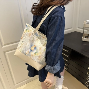 Floral embroidery mesh tote bag with cream leather trim shown on a denim dress